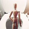 A figure staying in front of the toilet bowel feeling stuck suggesting constipation.