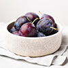 Plums in a deep bowl as fruits for constipation