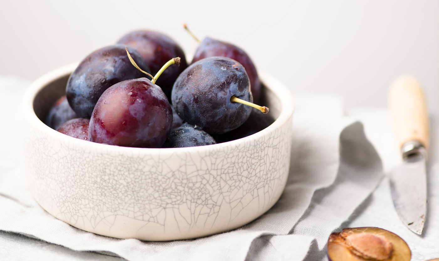 plums in a deep bowl as fruits for constipation