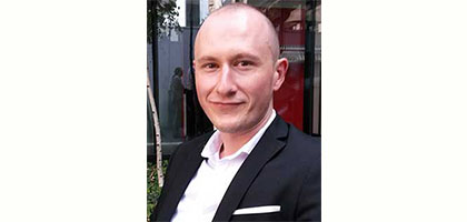 Dr. Horia Marculescu, MD, in a white lab coat at Carol Davila University of Medicine and Pharmacy in Bucharest.