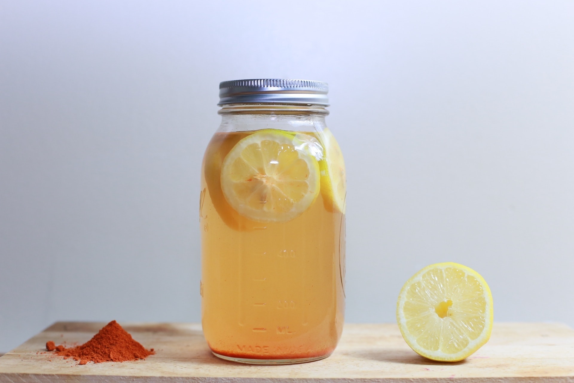 A transparent bottle full of lemon water sits on the table, suggesting immediate constipation relief for adults.